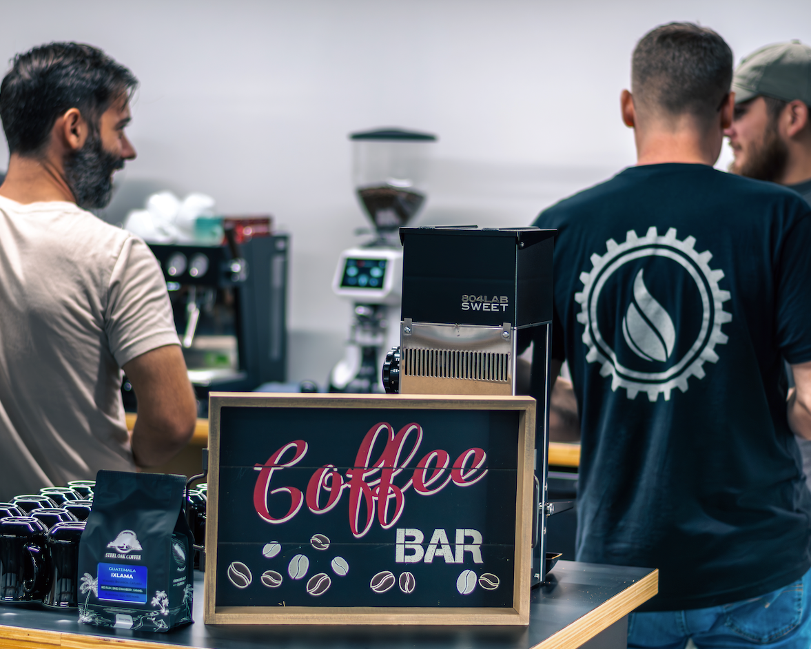 Three men gathered around the espresso coffee bar at Steel Oak Coffee Ormond Beach Florida