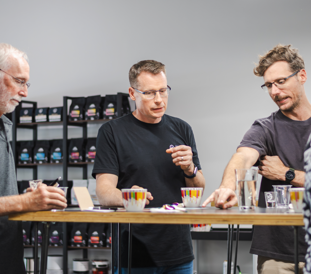 Three men participating in a specialty coffee cupping session on Friday at Steel Oak Coffee